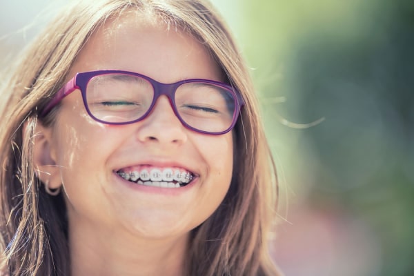 Orthodontics A smiling little girl with braces on her teeth